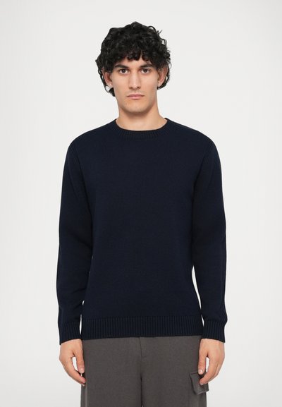 Maglione a maglia blu navy con scollatura rotonda, maniche lunghe e polsini e orlo a coste. Il tessuto appare morbido con una texture liscia.
