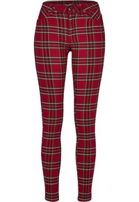 Jeans skinny carreaux rouges avec une coupe ajustée, arborant des motifs de carreaux verts et jaunes, cinq poches et une fermeture à bouton à la taille.