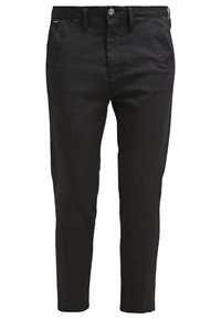 Chinos noirs pour homme, coupe slim, avec poches avant, passants pour ceinture, fermeture par bouton et braguette zippée.