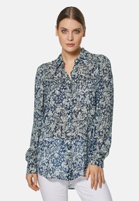 Marinebluse mit floralem Muster, aus leichtem Stoff, mit durchgehender Knopfleiste, langen Ärmeln und einem spitzen Kragen in lässiger Passform.