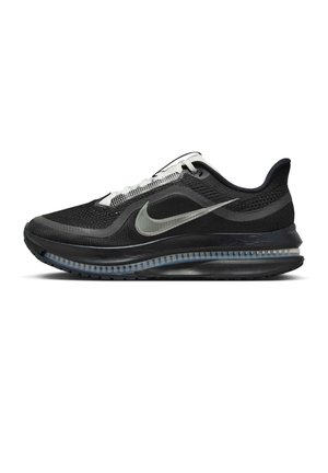 Scarpa da corsa Nike nera e grigia con lacci bianchi, ammortizzazione visibile Air Sole e tomaia in tessuto mesh traspirante.