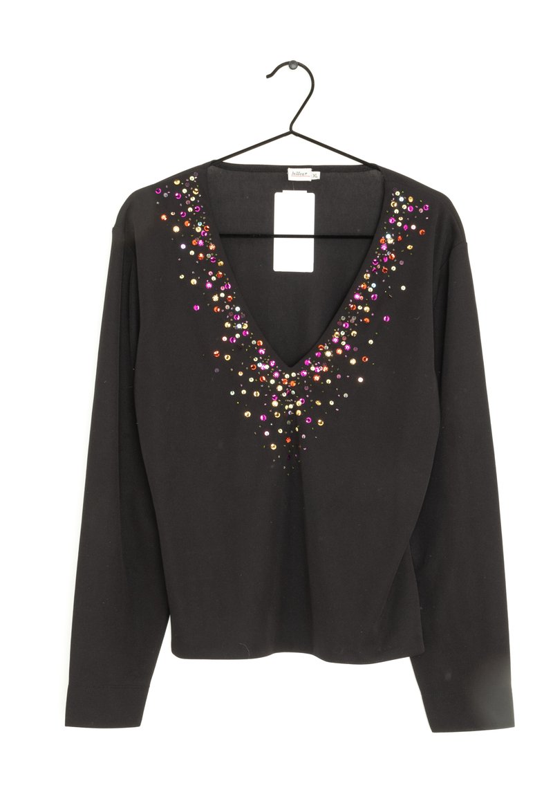 Svart långärmad topp med djup V-ringning, prydd med färgglada paljetter som hänger ner från halsringningen.