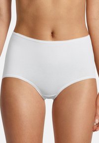 Woman wearing plain white high-waist cotton briefs with lace trim, shown from waist to upper thighs on neutral background.