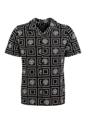 Chemise noire à manches courtes avec boutons, présentant des motifs de carrés blancs et de soleils disposés en grille sur le tissu.