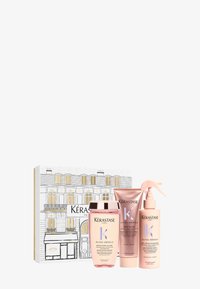 Set regalo Kérastase Gloss Absolu con tre bottiglie rosa: shampoo, glazé e spray anti-frizz. Confezionato in una scatola decorativa con accenti dorati.