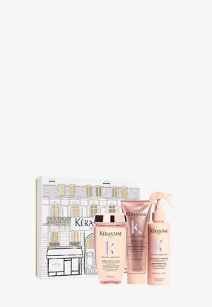 Set regalo Kérastase Gloss Absolu con tre bottiglie rosa: shampoo, glazé e spray anti-frizz. Confezionato in una scatola decorativa con accenti dorati.