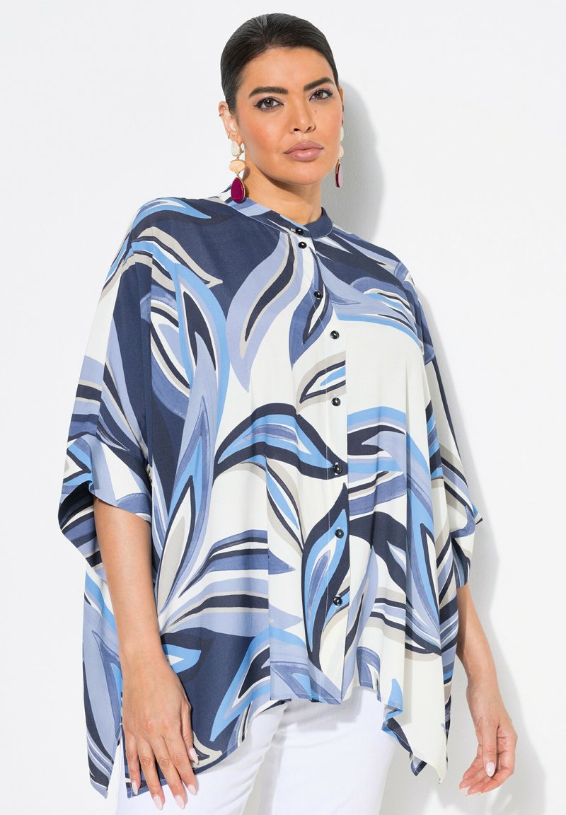 Loose-fit blouse in blue, navy, and white, featuring a leaf pattern, button closure, and short sleeves. Made from a lightweight, smooth fabric.