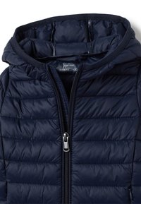 Chaqueta acolchada de color azul marino con capucha, que presenta un cierre de cremallera completo y un acabado acolchado horizontal. La etiqueta interior indica la talla.