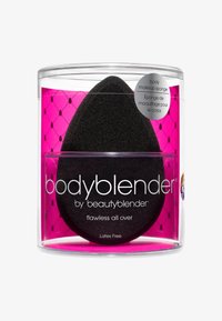 Zwarte latexvrije bodymake-up spons in ei-vorm, verpakt in een transparante cilindrische container met een roze patroon inzet.