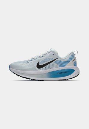 Nike running shoe in light gray with blue accents. Features breathable mesh upper, black swoosh, and a ZoomX cushioned sole.
