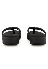 Black flip-flops with a flat sole, thick rubber straps, and a textured footbed. Features a slight heel for added lift.