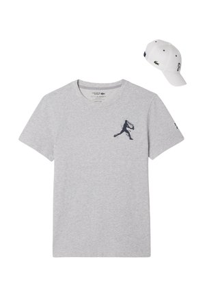 Harmaa puuvillapaita, jossa on musta graafinen logo rinnassa, ja valkoinen lippis, jossa on logo edessä ja sivussa.