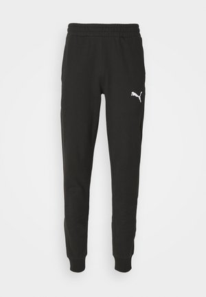 Mustad mustad teksad elastse vöökoha, kitsenevate jalgade ja valge Puma logoga vasakul reiel. Valmistatud pehmest kangast, millel on sile tekstuur.