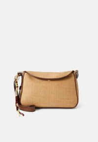 Tan woven handbag with a curved flap, brown leather trim, and adjustable strap. Features a decorative tassel and textured surface.