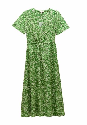 Grünes Blumenkleid mit kurzen Ärmeln, V-Ausschnitt, taillierter Taille und fließendem Rock. Besetzt mit weißen Blumenmustern auf einem strukturierten Stoff.