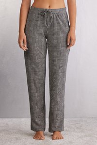 Zwart-witte geruite pyjamabroek met een trekkoord in de taille, losse pasvorm en een gladde stofstructuur, met rechte pijpen en zonder zakken.