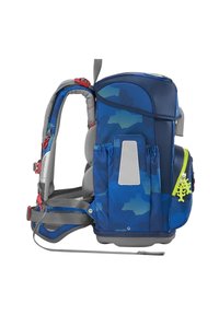 Child carrier backpack in blue with green accents, padded support, multiple straps, mesh panels, and decorative hardware. Features a camouflage pattern.