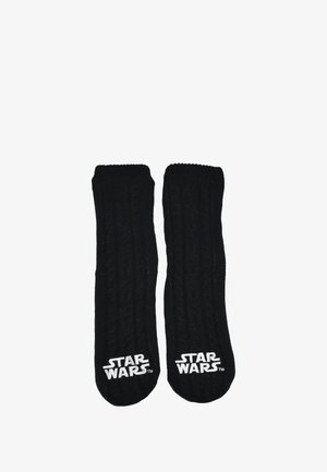 Calze nere lavorate a maglia con motivo a treccia, con logo bianco "STAR WARS" vicino all'area delle dita. Tessuto morbido e lunghezza a metà polpaccio.