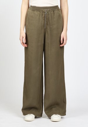 Khaki wide-leg pants with an elastic waistband and a zipper detail. Made of smooth fabric, they have a relaxed fit and subtle draping.