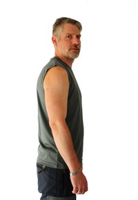 Sleeveless gray athletic shirt with a smooth texture and crew neck, worn with dark pants, showcasing a side profile of the model.