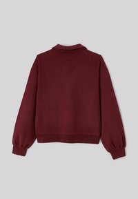 Sweat-shirt bordeaux à coupe décontractée, avec des poignets côtelés et un col classique. Fabriqué en tissu doux et texturé, avec une couleur unie.