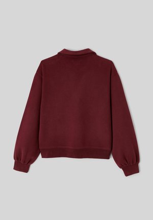 Sweat-shirt bordeaux à coupe décontractée, avec des poignets côtelés et un col classique. Fabriqué en tissu doux et texturé, avec une couleur unie.