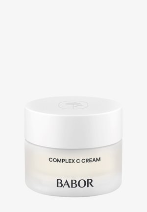 Pot blanc de BABOR Complex C Cream avec un design minimaliste et un couvercle blanc avec un logo feuille subtil sur le dessus.