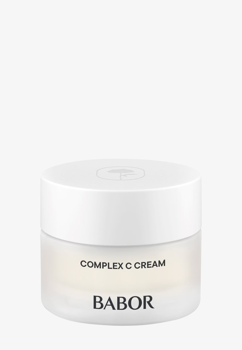 Pot blanc de BABOR Complex C Cream avec un design minimaliste et un couvercle blanc avec un logo feuille subtil sur le dessus.