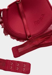 Bordeaux polstret bh med blonder trim og justerbare stropper. Har en hægte-og-løkke lukning og glat, glat materiale.