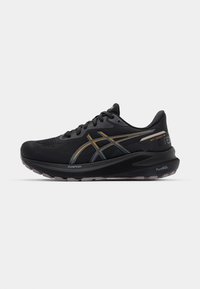 Black athletic shoes with a textured upper, featuring gold and silver accents, a cushioned sole labeled "FlyteFoam" and "PureGEL."