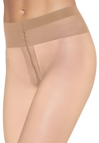 Leggings beige opachi con una texture liscia, ampia vita elastica e un minimalissimo dettaglio delle cuciture lungo la parte anteriore della gamba.