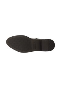 Zwarte rubberen zool van de schoen met een gestructureerd oppervlak, gekenmerkt door kleine ronde patronen en een glad accent bij de hiel, gemarkeerd met "Woolos."