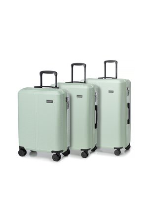 Three mint green hard-shell suitcases with a ridged design, black handles, and wheels. Varying sizes for different travel needs.