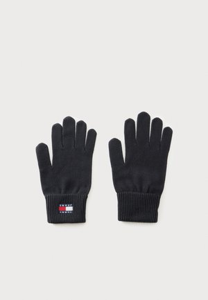 Par de guantes de punto negros con puños de canalé, un guante muestra un pequeño parche rectangular con el logo de Tommy Jeans en la muñeca.