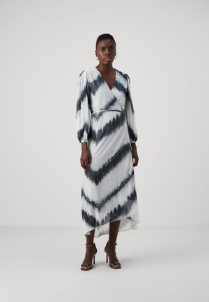 White and black tie-dye wrap dress with long puff sleeves, a V-neckline, and an asymmetrical hem, made of smooth fabric.