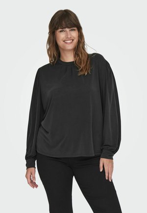 Svart genser med lange puff ermer, rund halsutringning og myk tekstur. Stoffet faller løst over kroppen og komplementerer svarte bukser.