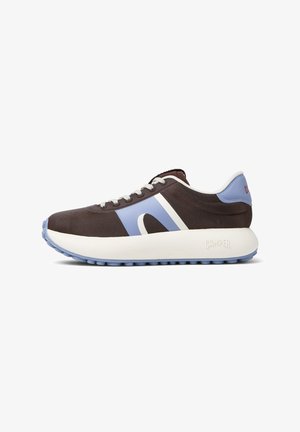 A brown and blue sneaker with a white sole, featuring a curved design and contrasting stripes, positioned against a white background.