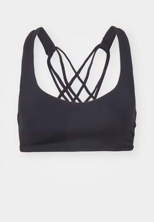 Czarny stanik sportowy z dekoltem w kształcie łódki i krzyżującymi się ramiączkami z tyłu. Wykonany z elastycznego materiału o gładkiej strukturze.