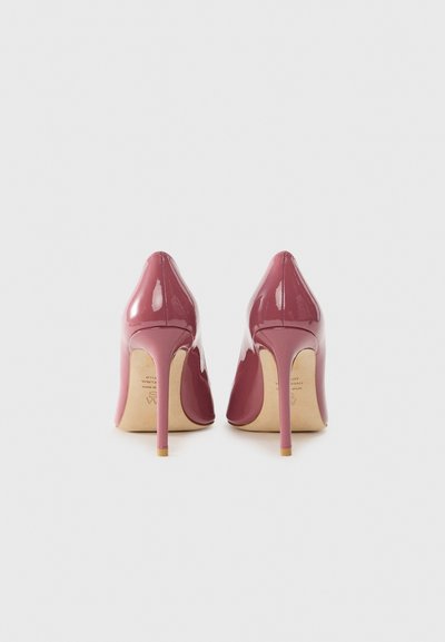 Glossy burgundy high heels with a pointed toe design, thin stiletto heel, and a smooth patent finish. Light-colored sole visible.
