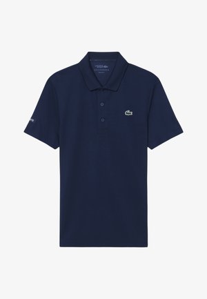 Polo Lacoste blu navy con colletto, tre bottoni e piccolo logo coccodrillo verde sul petto a sinistra.