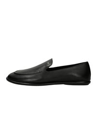 Black leather slip-on loafer with low heel and minimalist stitching detail, shown in side profile on white background.