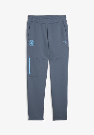 Pantalon de sport bleu-gris avec taille élastique, poche zippée sur le côté, logo Manchester City sur la cuisse gauche et logo Puma sur la cuisse droite.
