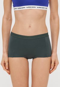 Tmavozelené bavlnené boxerské šortky s hladkým povrchom a širokým elastickým pásom so zeleným logom "BJÖRN BORG".