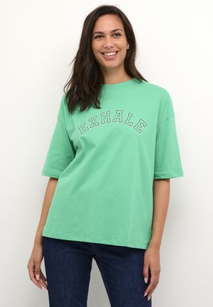 Green cotton t-shirt with short sleeves, featuring an “EXHALE” graphic in white outlined letters across the chest. Simple, relaxed fit.