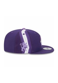Purple cap featuring a textured fabric, a raised lion emblem, and white striped accents on the side. Flat brim design, adjustable fit.