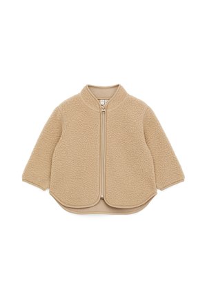Veste beige pour tout-petit avec fermeture éclair, en polaire douce et texturée, manches longues et ourlet arrondi.