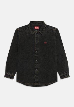 Chemise en jean noire à manches longues avec boutons, col, logo Diesel rouge sur la poitrine et étiquette à l'intérieur du col, détails de couture visibles.