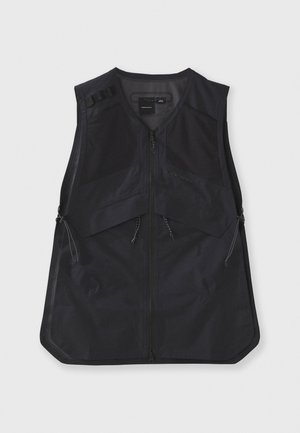 Black vest with a zip front, featuring a structured design, mesh panels, and adjustable side cords for a customizable fit. Lightweight material.