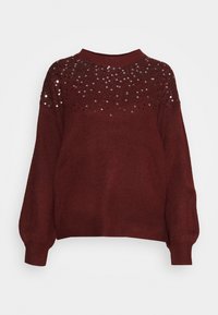 Pull en bordeaux avec un col rond, présentant un motif brodé de sequins sur la partie supérieure et des manches ballon.