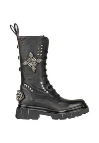 Stivale da combattimento in pelle nera con suola spessa, borchie metalliche decorative, embellimenti di cristallo a forma di fiori e cuori, e allacciatura frontale.